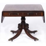 A George IV mahogany sofa table, on quadruple legs with brass paw castors, 132cm l