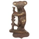 A brass door knocker in the form of the Dudley family bear and ragged staff emblem, inscribed