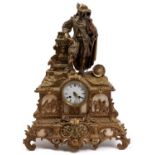 A French gilt spelter mantel clock, c1870, the ornate case with figure beside a pillar, a helmet