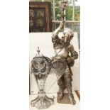 A silvered metal figural lamp in the form of a knight in armour, 104cm h and chromium plated fan