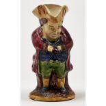 A Staffordshire majolica snuff taker Toby jug, late 19th c, 25cm h