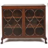 A mahogany display cabinet, c1930, the rectangular top above a figured shallow frieze enclosed by