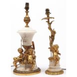 A giltmetal mounted turned alabaster table lamp, with the figures of three seated putti, each