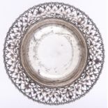A George V saw pierced silver fruit bowl, with gadrooned rim, on three legs, 25.5cm diam,
