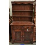 A panelled oak dresser and rack, the lower part with carved doors, 171cm h; 93cm w