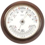 An oak framed aneroid barometer with thermometer, the cream pottery dial inscribed Henry Robinson,