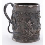 AN INDIAN SILVER COLOURED METAL EMBOSSED AND REPOUSSE DECORATED CYLINDRICAL MUG, LATE 19TH C, THE
