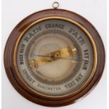 A walnut cased aneroid barometer, first quarter 20th c, the glass reverse printed in black with