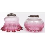 Two cranberry glass lampshades, early 20th c, one of quilted thistle form, the other etched with