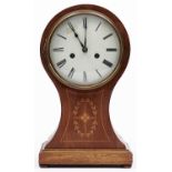 An inlaid mahogany balloon shaped mantel clock, first half 20th c, the cream enamel dial with