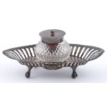 A Victorian silver mounted cut glass inkwell, on pierced silver stand, 14.5cm l, Chester 1900, 1oz