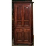 A George III mahogany standing corner cupboard, late 18th c, with moulded breakfront cornice and