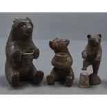 Three Swiss miniature limewood carvings of bears, late 19th/early 20th c,  two seated on their