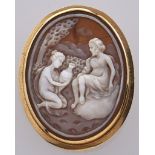 A cameo brooch, the oval shell carved with two figures, in gold marked 750, 3.6g Wear consistent