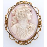 A white coral cameo of the head of a bacchante, set in a gold brooch, early 20th c, 13.9g Cameo in