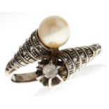 A cultured pearl and paste crossover ring, in white gold, 3.5g, size R White paste slightly