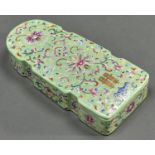 A Chinese lime green ground famille rose box and cover, enamelled with formal lotus meander and bat,
