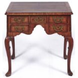 A George II walnut and featherbanded lowboy, mid 18th c, the quarter veneered top with moulded