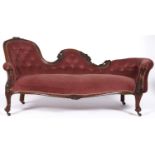 A Victorian walnut chaise longue, the moulded frame carved with pendant flowers and leafage,