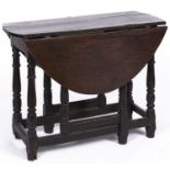 A oak gateleg table, late 17th c, the plank top with pair of folding D-shaped leaves on ring