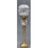 An Edwardian brass columnar oil lamp, with faceted cut glass fount and brass burner, etched glass