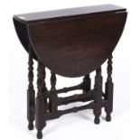 An oak gateleg table, c1910, the oval top with D-shaped leaves on turned tapered baluster turnings