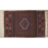 A modern Caucasian kilim, worked to the centre with a geometric medallion in brown and indigo framed