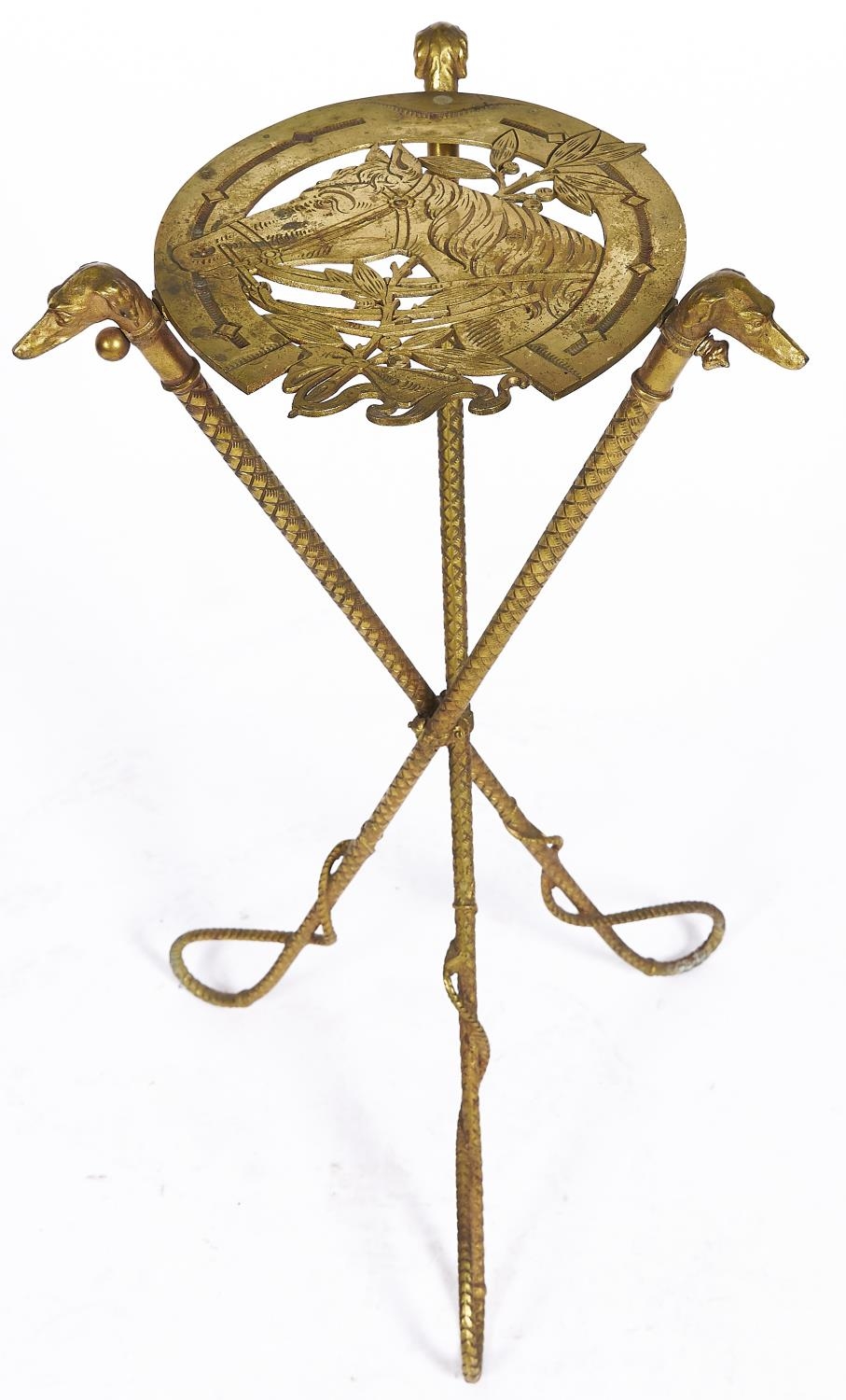 An unusual gilt lacquered iron stand, c1890, the horseshoe shaped openwork top with the head of a