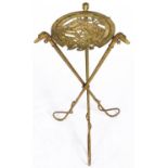 An unusual gilt lacquered iron stand, c1890, the horseshoe shaped openwork top with the head of a