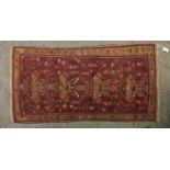 A Caucasian multi coloured bordered rug, the brown ground worked with four stylise floral filled