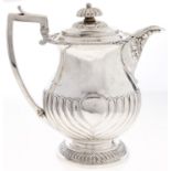 A George III silver lidded jug, of baluster form, spirally reeded, integral hinge to the domed