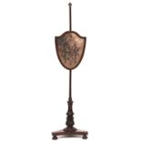 A George IV mahogany polescreen, with shield shaped banner frame, 144cm h Evident from image
