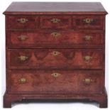 A George II walnut and feather banded chest of drawers, having quarter veneered top and fitted three