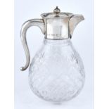 A Victorian silver mounted cut glass claret jug, of bag shape, 19.5cm h, marks rubbed, London 1900