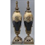 A pair of decorative black and gilt glass and bronzed metal table lamps, late 20th c, decorated with