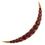 A ruby crescent brooch, early 20th c, in gold, 52mm, marked [1]5 ct, 4.5g Good condition