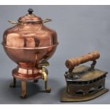 A copper tea urn and cover with brass tap, 45cm h and a decorative brass flat iron Good condition