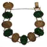 A Chinese carved jade mounted gold bracelet, early 20th c, with alternate panels of shou