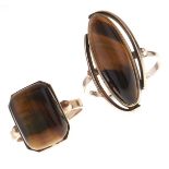 Two tiger's eye rings, in gold marked 9ct, 11.9g, sizes T and Q Good condition