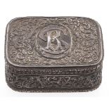 An Indian oblong silver repousse box, c1900, the lid worked with a monogram reserved on foliage,