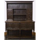 A Jacobean revival oak dresser, c1920, the top with flared cornice above bordered back with