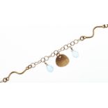 A gold bracelet, suspended with briolette cut aquamarines, marked 750, 5g Good condition