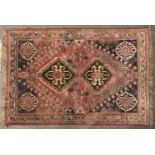 A modern Caucasian multicoloured bordered rug, the salmon pink field worked with two geometric