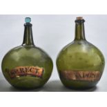 Two similar English pear shaped glass utility bottles, early 19th c, with early gilt labels LIN