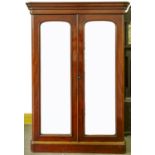 A Victorian mahogany double wardrobe, c1870, with flared moulded cornice and shallow frieze, pair of