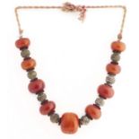 A North African necklace of amber and metal beads, Arab-Berber people, 20th c, 292g Aged patina