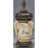 A Victorian oxidised and gilt brass mounted Royal Worcester owl lamp, moulded in relief with