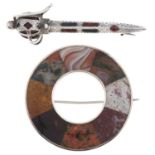 Scottish jewellery. A silver and hardstone inset claymore brooch and a plaid brooch, late 19th c,