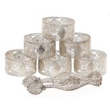 A set of six silver filigree napkin rings and a pair of similar sugar bows, c1900, unmarked, 3ozs