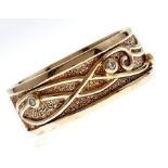 Welsh Gold. A Celtic style diamond set 9ct gold band, Clogau box, 10.5g, size Y A few fine light